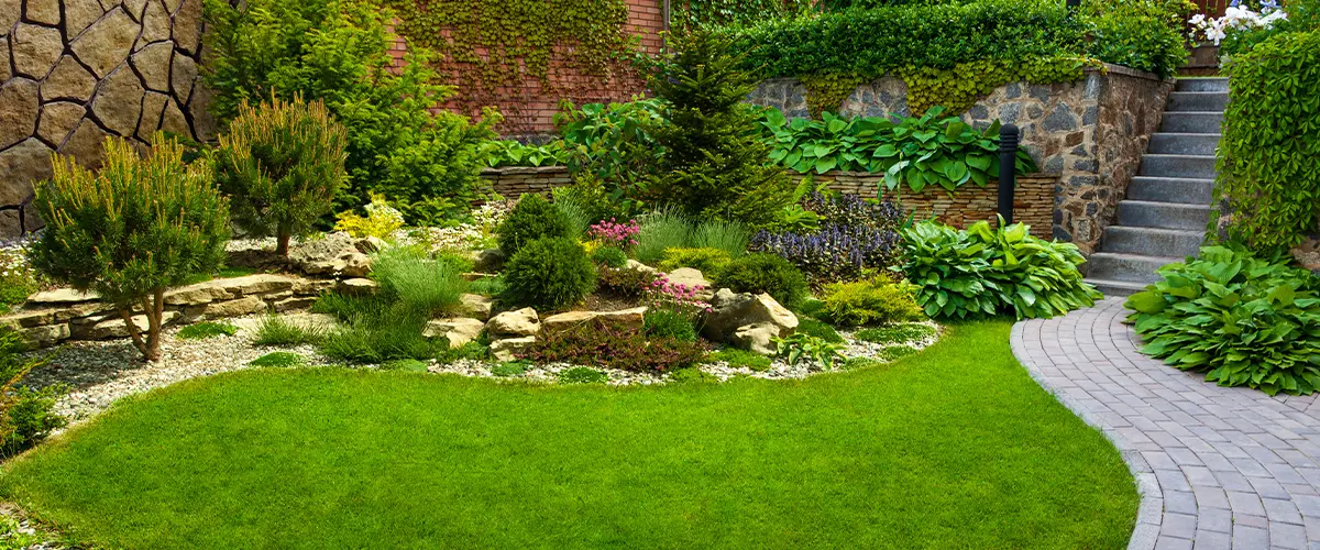 Beautiful landscaped garden with stone accents, trees, and shrubs.