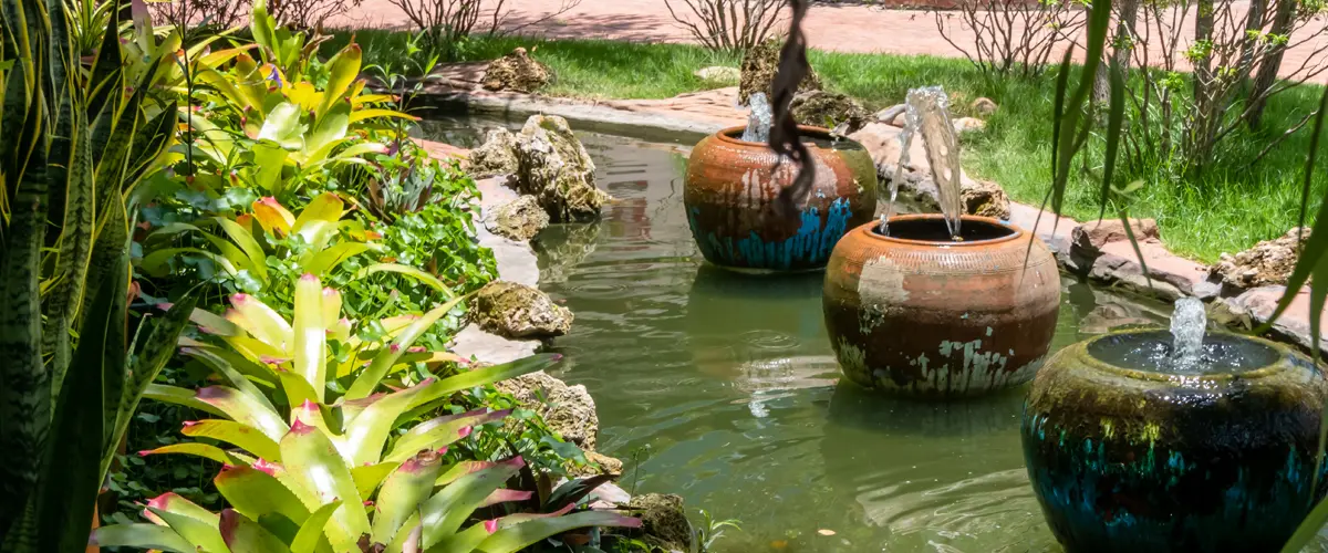 Decorative pottery fountains in a landscaped pond