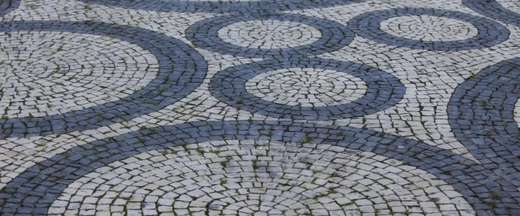 circular patterned stone paver patio with blue and gray mosaic design