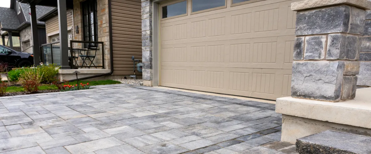 a residential driveway constructed with concrete pavers